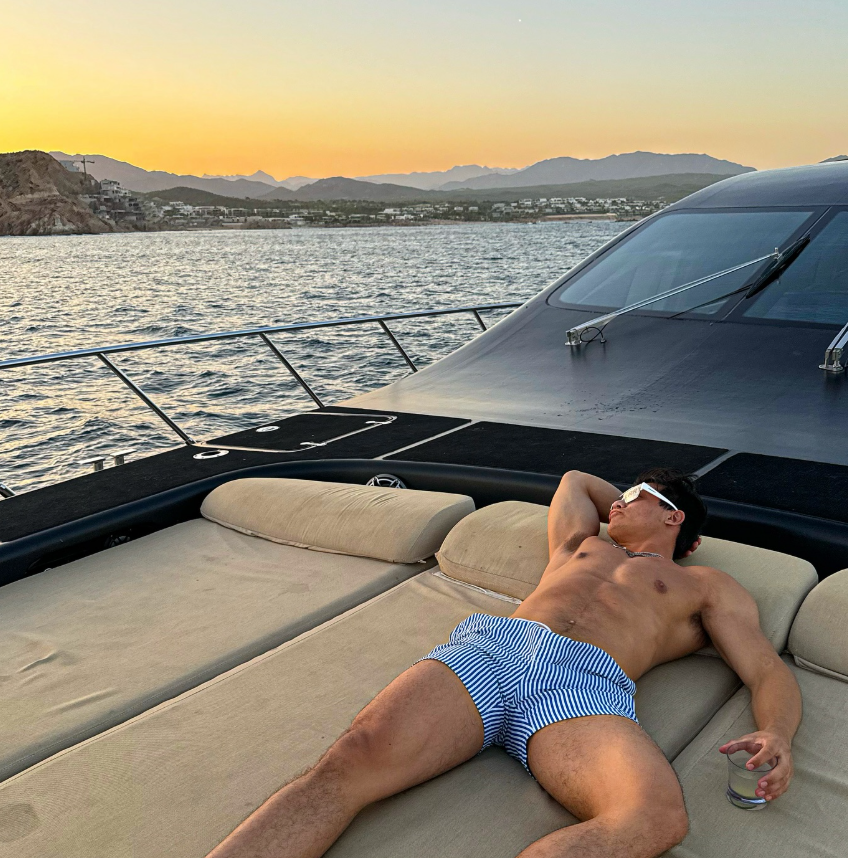 TOGSTER relaxing on a yacht at sunset